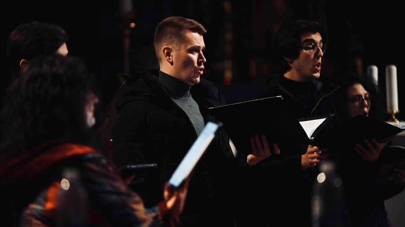 Portait picture of member of the Vikra Chamber Choir singing in Ljubljana