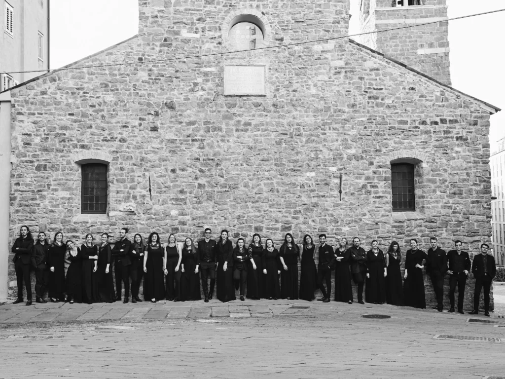 Group photo of the choir in front of a church